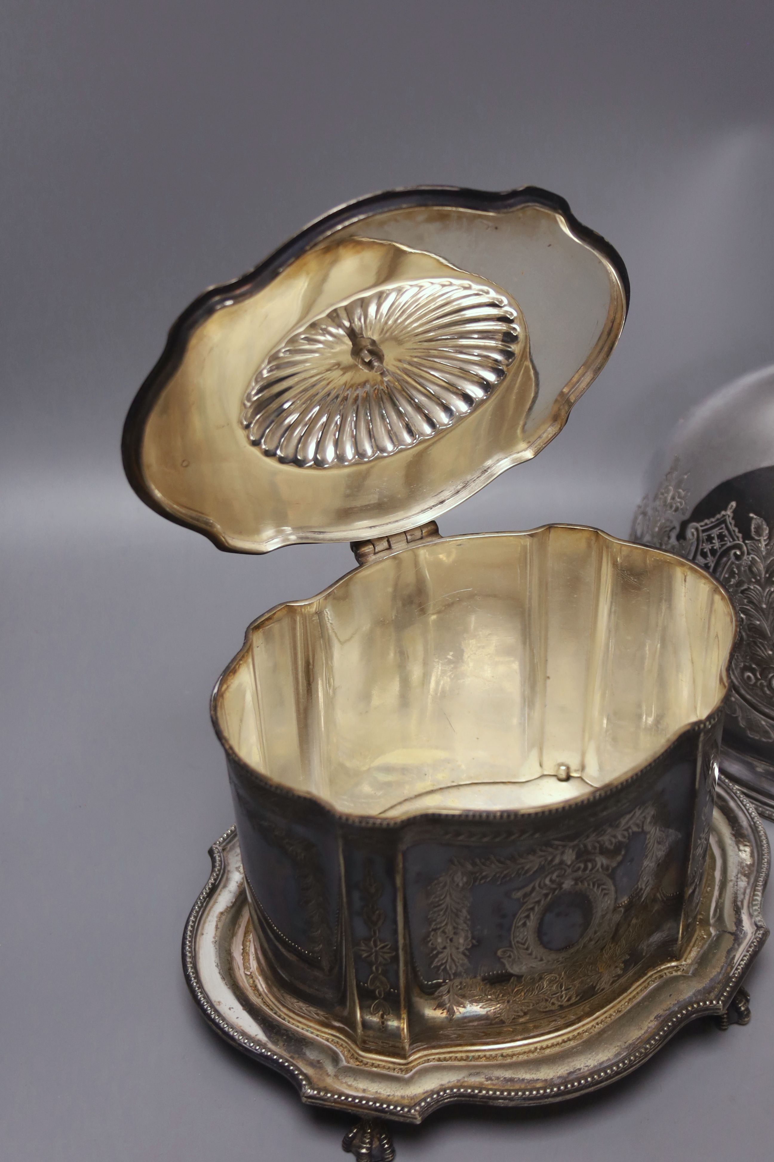 A French silver plated biscuit barrel and a meat dish cover